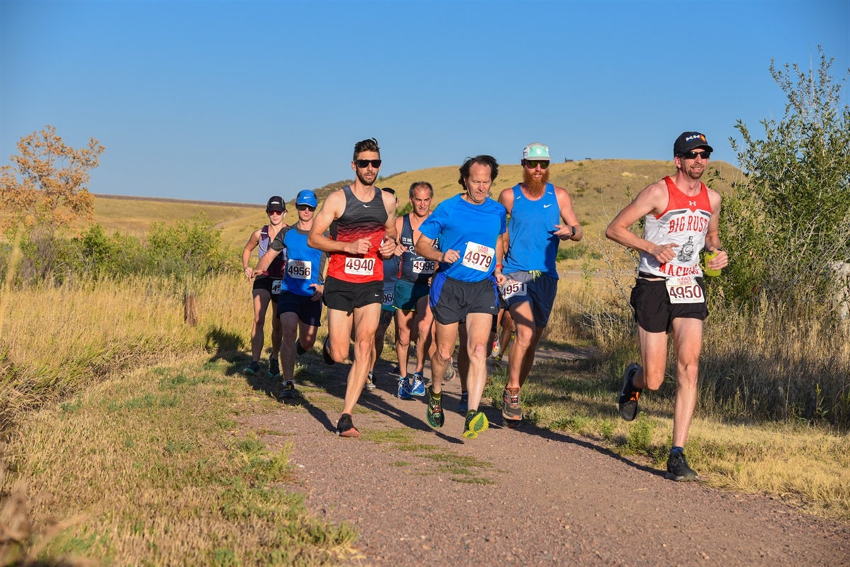 group of men trail running in a race
